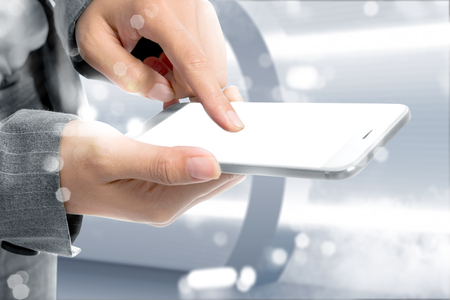 Business woman touch the mobile phone with white blank screen for copyspace. Future technology conceptの写真素材