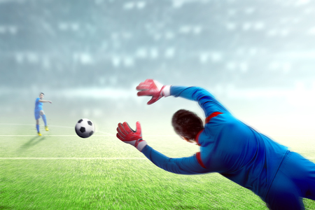 Asian football player man kicking the ball to the goal on football field at stadiumの写真素材