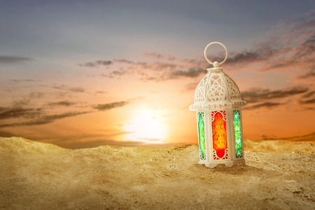 Arabic lamp with beautiful light on the sand dunes with sunset backgroundの写真素材