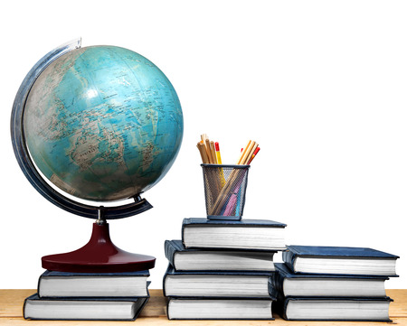 Pile of books and globe with pencils in basket container on wooden table isolated over white background. Back to School conceptの写真素材