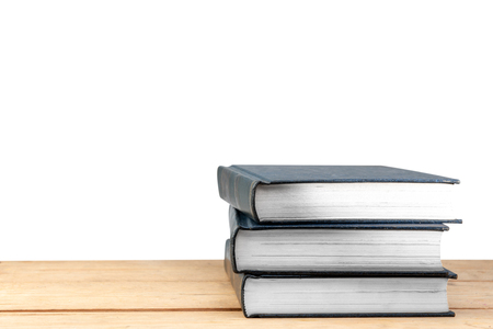 Pile of books on wooden table isolated over white background. Back to School conceptの写真素材
