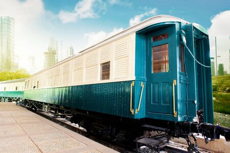 Train wagon in a station with city and blue sky backgroundの写真素材