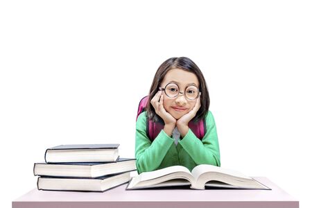 Asian cute girl with glasses and backpack with books on the desk isolated over white backgroundの写真素材