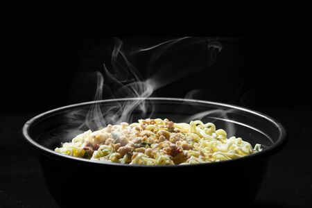 Noodles over black backgroundの写真素材
