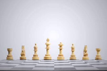 Row of wooden chess pieces on the chessboardの写真素材