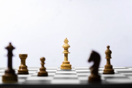 Wooden king chess piece standing on the chessboard