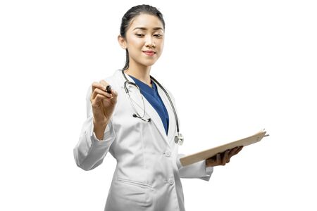 Asian woman doctor in a white lab coat and stethoscope holding the clipboard and using pen isolated over white backgroundの写真素材