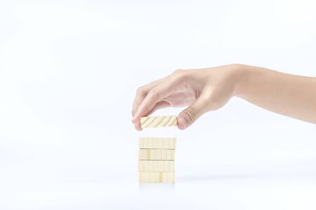 Hand build a stack of wooden block toy isolated over white background