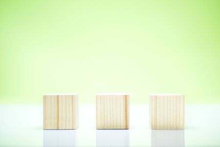 Wooden block toy on the table over green background