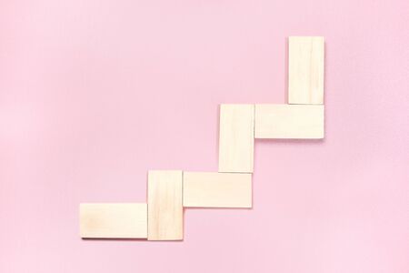 Staircase of wooden block toy over pink background