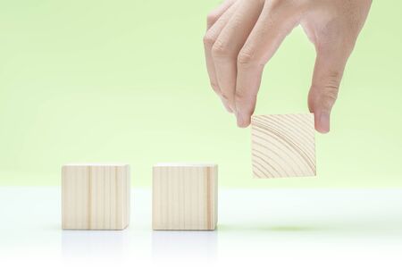 Wooden block toy on the table over green background
