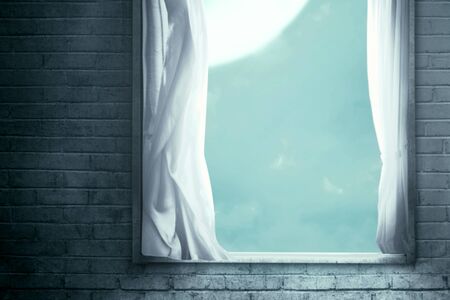 Windows with the curtain in an abandoned house with moonlight backgroundの写真素材