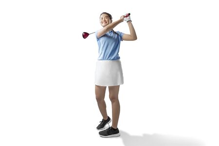 Asian woman swing the wood golf club isolated over white backgroundの写真素材