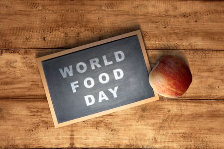 Apple fruit and chalkboard with World Food Day text on wooden background. World Food Dayの写真素材