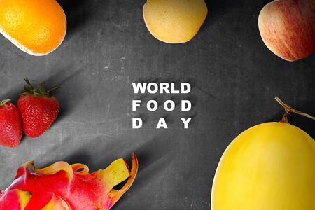 Various kinds of fruit with World Food Day text on black background. World Food Dayの写真素材