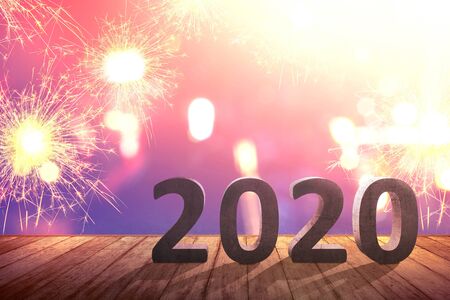 2020 on wooden table with fireworks background. Happy New Year 2020の写真素材