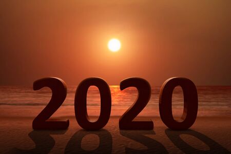2020 on the sandy beach with a sunset sky background. Happy New Year 2020の写真素材