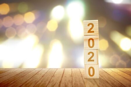 2020 on the stack of the wooden cube on the table. Happy New Year 2020