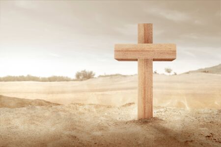 Christian cross on the sand with the desert backgroundの写真素材