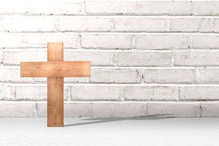 Christian cross on the floor with brick wall backgroundの写真素材