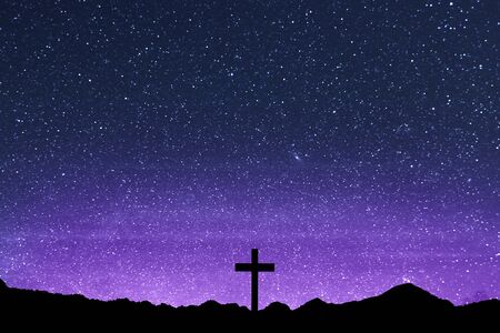 Christian Cross on the field with a night scene backgroundの写真素材
