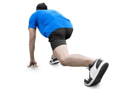 Rear view of Asian runner man in a ready position to run isolated over white backgroundの写真素材