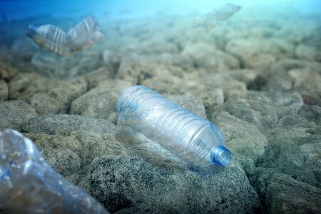 Underwater view with a plastic bottle on the ocean. Plastic pollution
