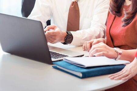 Business people with a laptop discussing business on the workplace