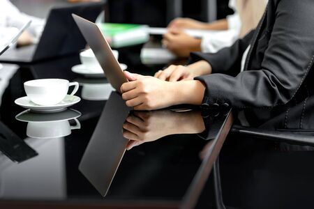 Businesswoman using a laptop on her desk on the workplace