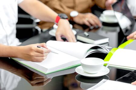 Businessman with a document on his desk discussing business on the workplace