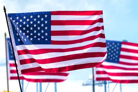 The United States of America flags waving in the air. Labor day concept