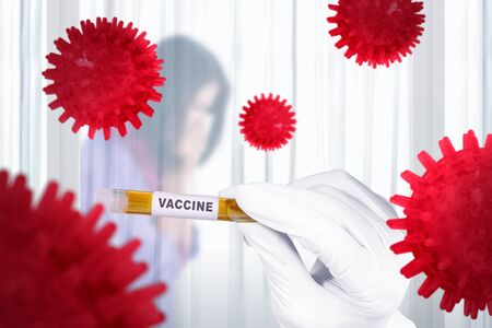 Doctor man in protective gloves holding a test tube with vaccine for stop spread coronavirus. Prevent flu disease Coronavirusの写真素材