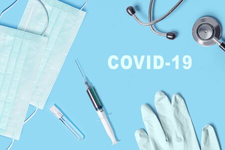 Syringe, stethoscope, glove, and medical mask with Covid-19 text. Prevent flu disease Coronavirusの写真素材