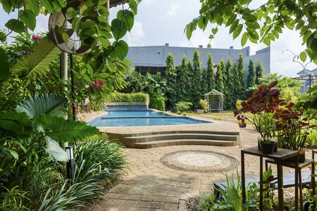 Housing park with green plants and pool with a blue sky backgroundの写真素材