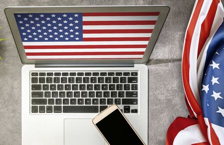 American flag on the desk and laptop screen. Fourth of July Conceptの写真素材