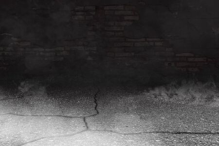 Cracked concrete floor with smoke and grunge wall backgroundの写真素材