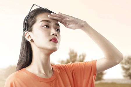 Asian woman looking at scenery view with a sky background