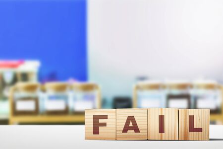The row of a wooden cube with the fail letter on the tableの写真素材