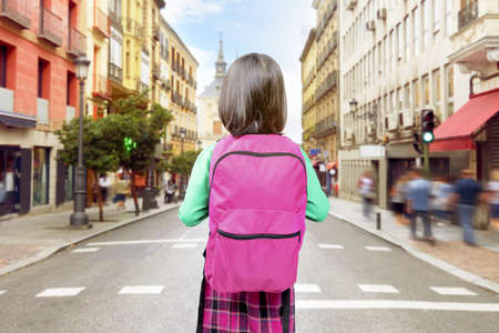 Rear view of Asian little girl with a backpack going to the school. Back to School conceptの写真素材