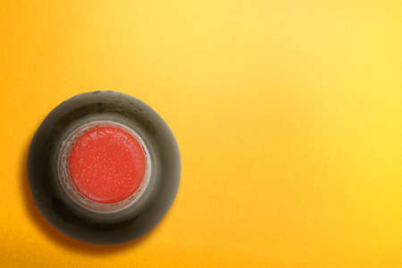 Top view of the beer bottle with a yellow background. Beer for celebrating Oktoberfest