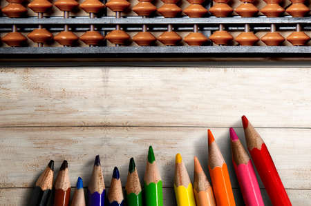 Abacus and colored pencils on wooden table. Back to School conceptの写真素材