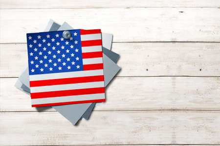 Stack of paper with color of an American flag hanging on the wooden wall. Happy Labor Day