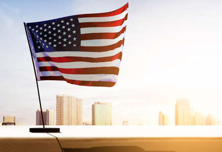 American flag waving in the air with cityscapes. Happy Labor Dayの写真素材