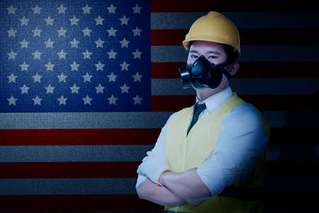 Asian construction worker with hardhat and safety mask standing with crossed arms. Happy Labor Day