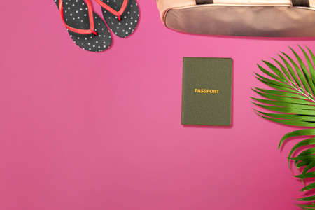 Top view of passport, slipper, and luggage bag with a colored background. World Tourism Day