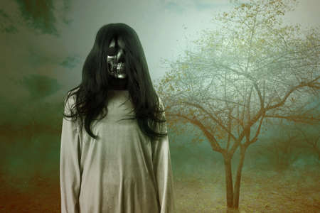 Scary ghost woman standing with haunted forest background. Halloween concept