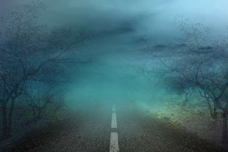 Haunted street with fog and moonlight background. Halloween conceptの写真素材