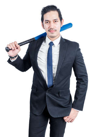 Asian businessman holding a baseball bat isolated over white backgroundの写真素材