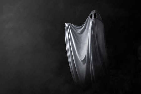 White ghost haunting with a dark background. Halloween conceptの写真素材