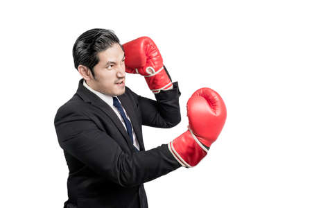 Asian businessman with red boxing gloves fighting isolated over white background